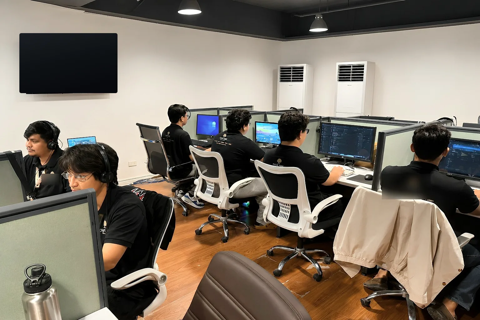 The BuildNextTeam team working at their desks in the Bohol office